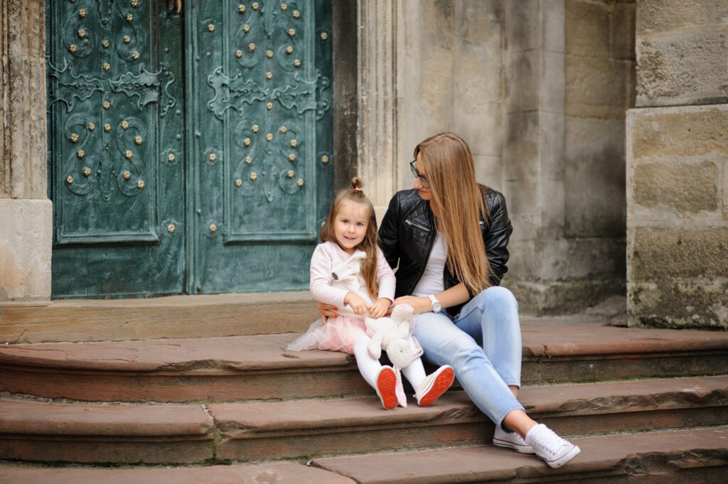 Mother and daughter sitting on steps.