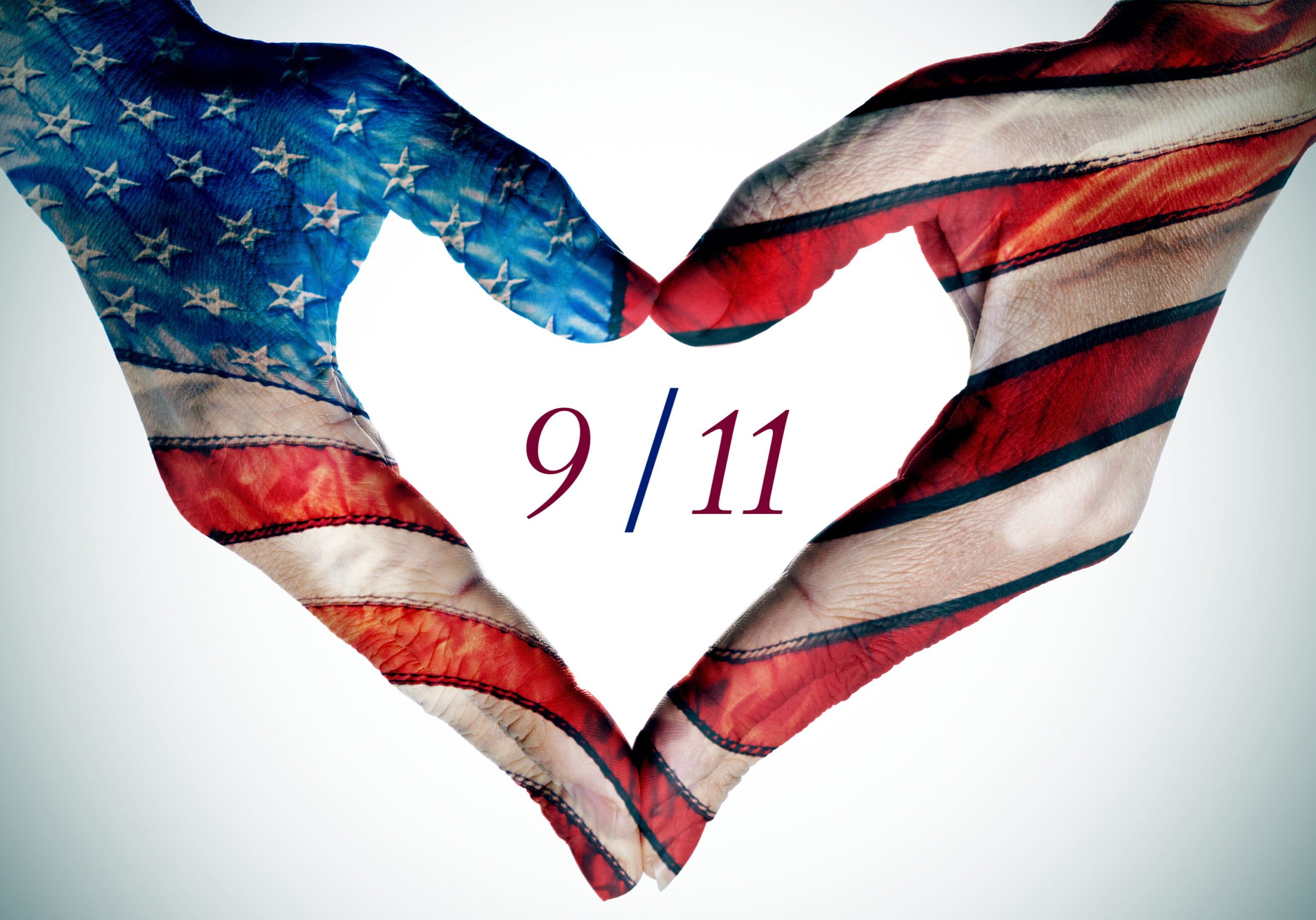 American flag hands in a heart shape with 9/11 text, symbolizing remembrance and unity.